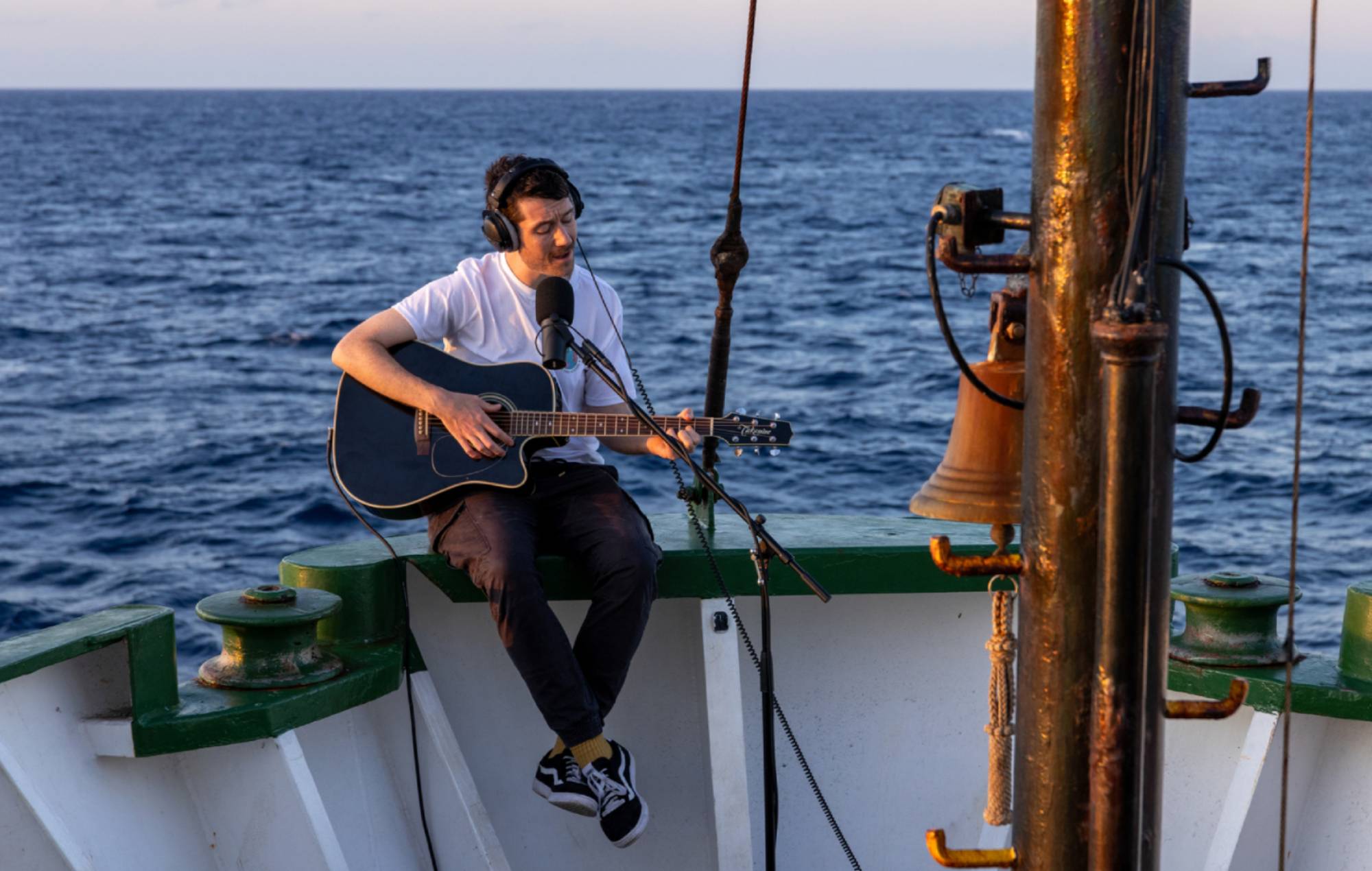 Dan Smith, Bastille playing guitar on board the Arctic Sunrise. Credit: PRESS