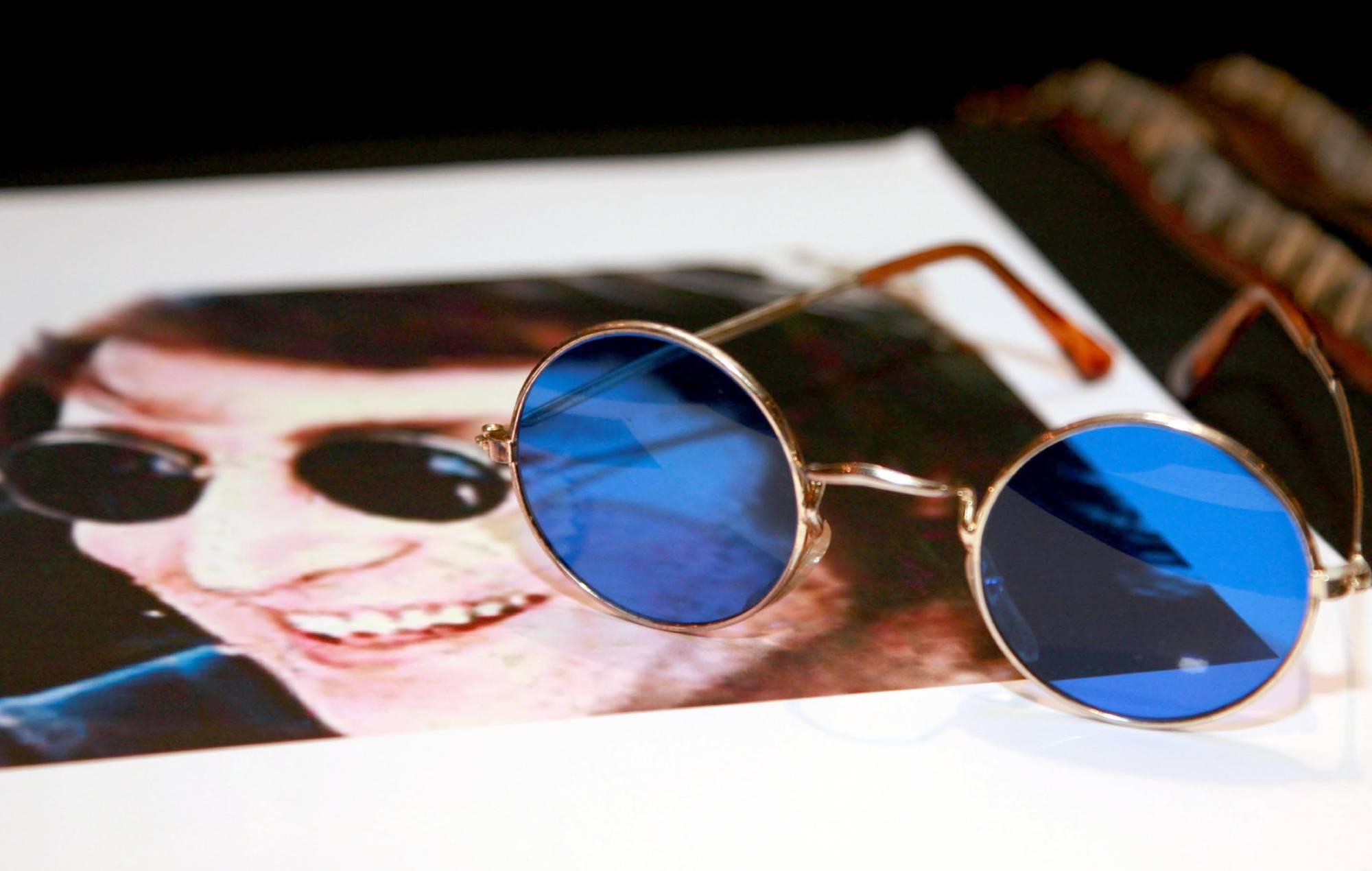 John Lennon's gold wire-rimmed glasses with blue lenses (Photo by Eamonn McCormack/WireImage)