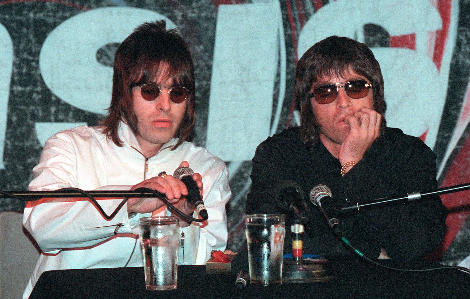 Liam and Noel Gallagher from Oasis at a press conference held in the Waterrats pub in London, August 25, 1999. The conference was called to announce the departure of the bands two founding member Guigsy and Bonehead, who were replaced by Gem Archer and Andy Bell. CREDIT: Gareth Davies/Getty Images