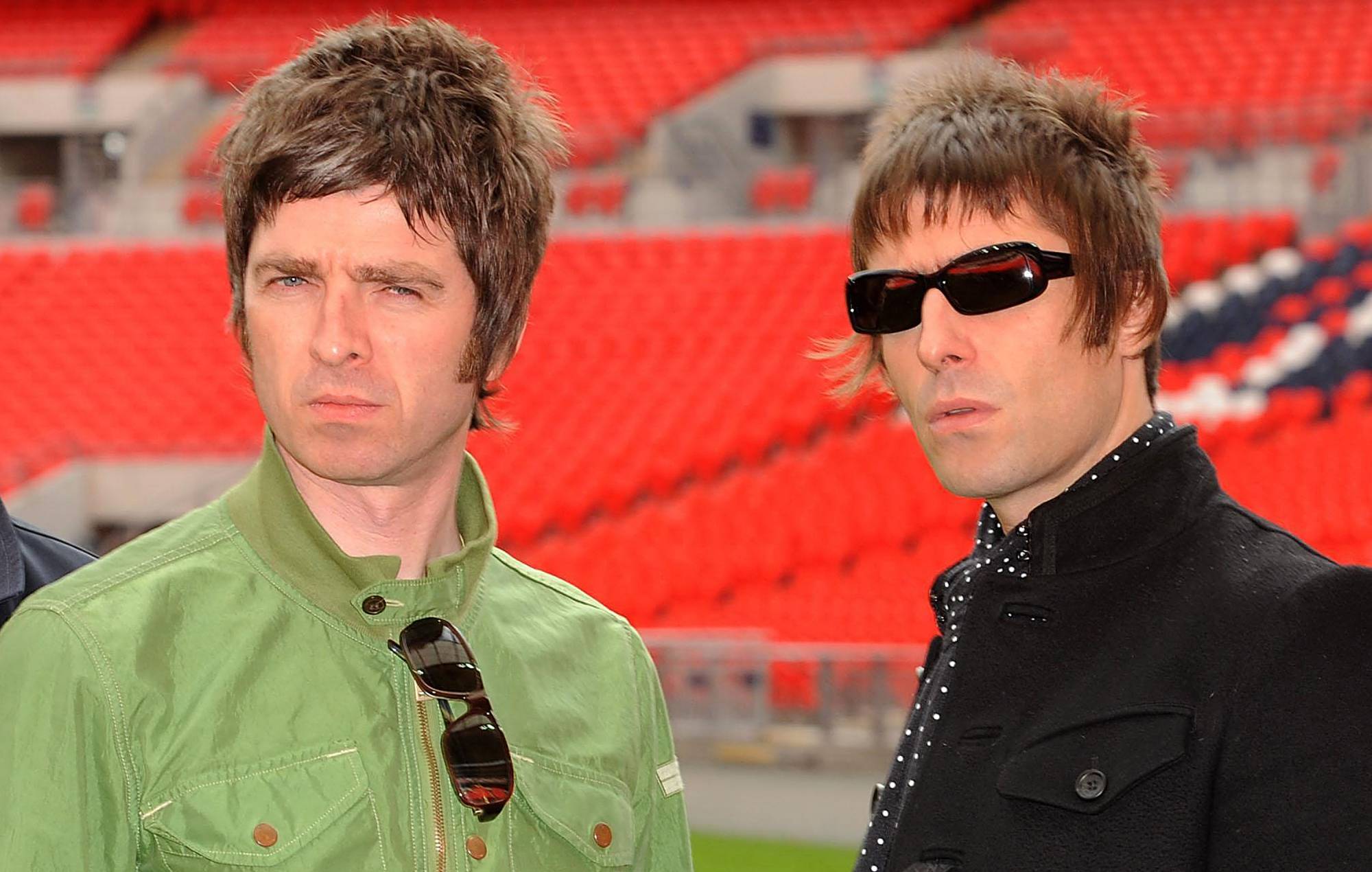 Noel Gallagher (left) and Liam Gallagher of Oasis pose at Wembley Stadium on October 16, 2008 in London, England. (Photo by Samir Hussein/Getty Images)