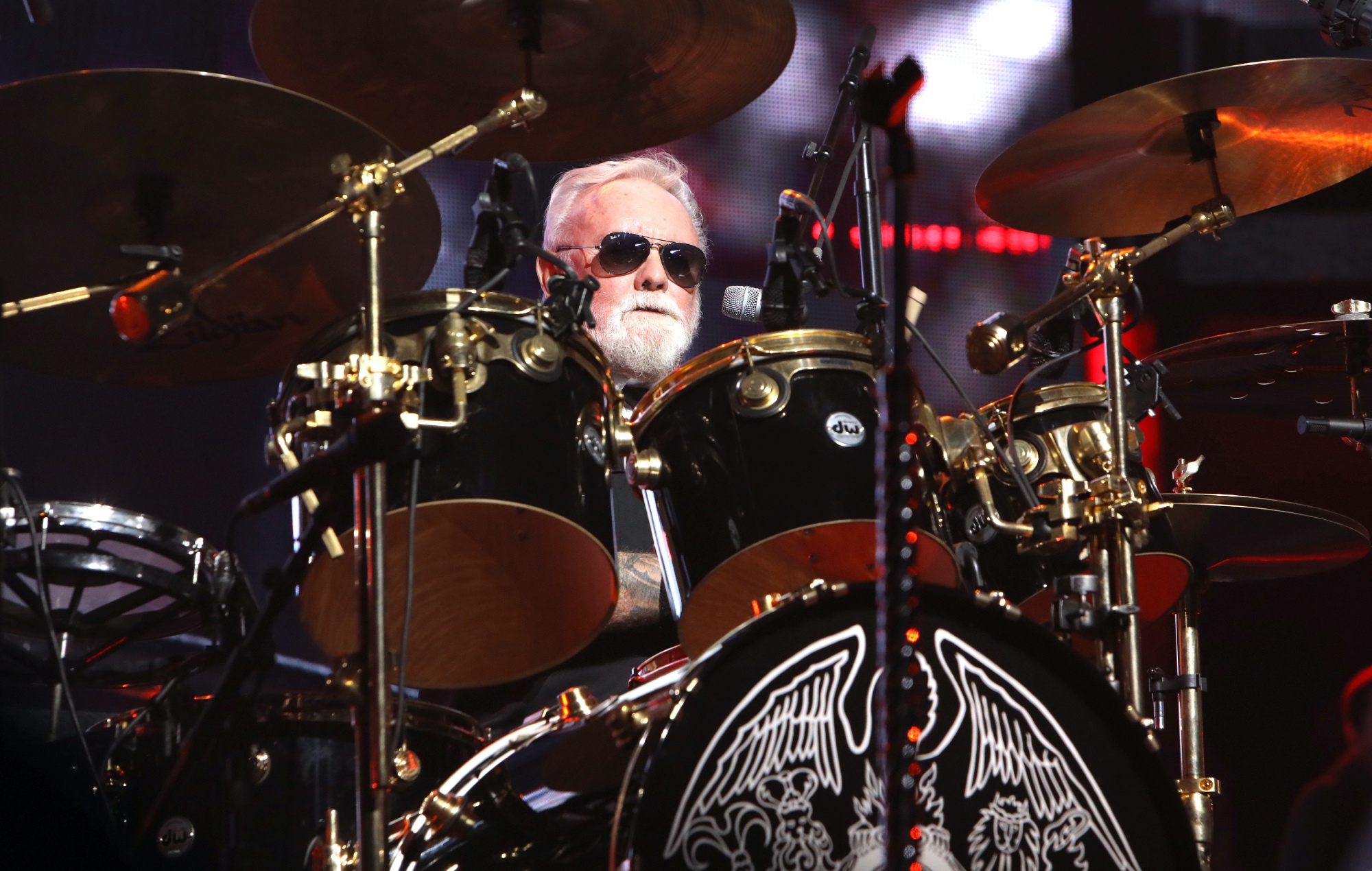 Roger Taylor performing live on stage with Queen