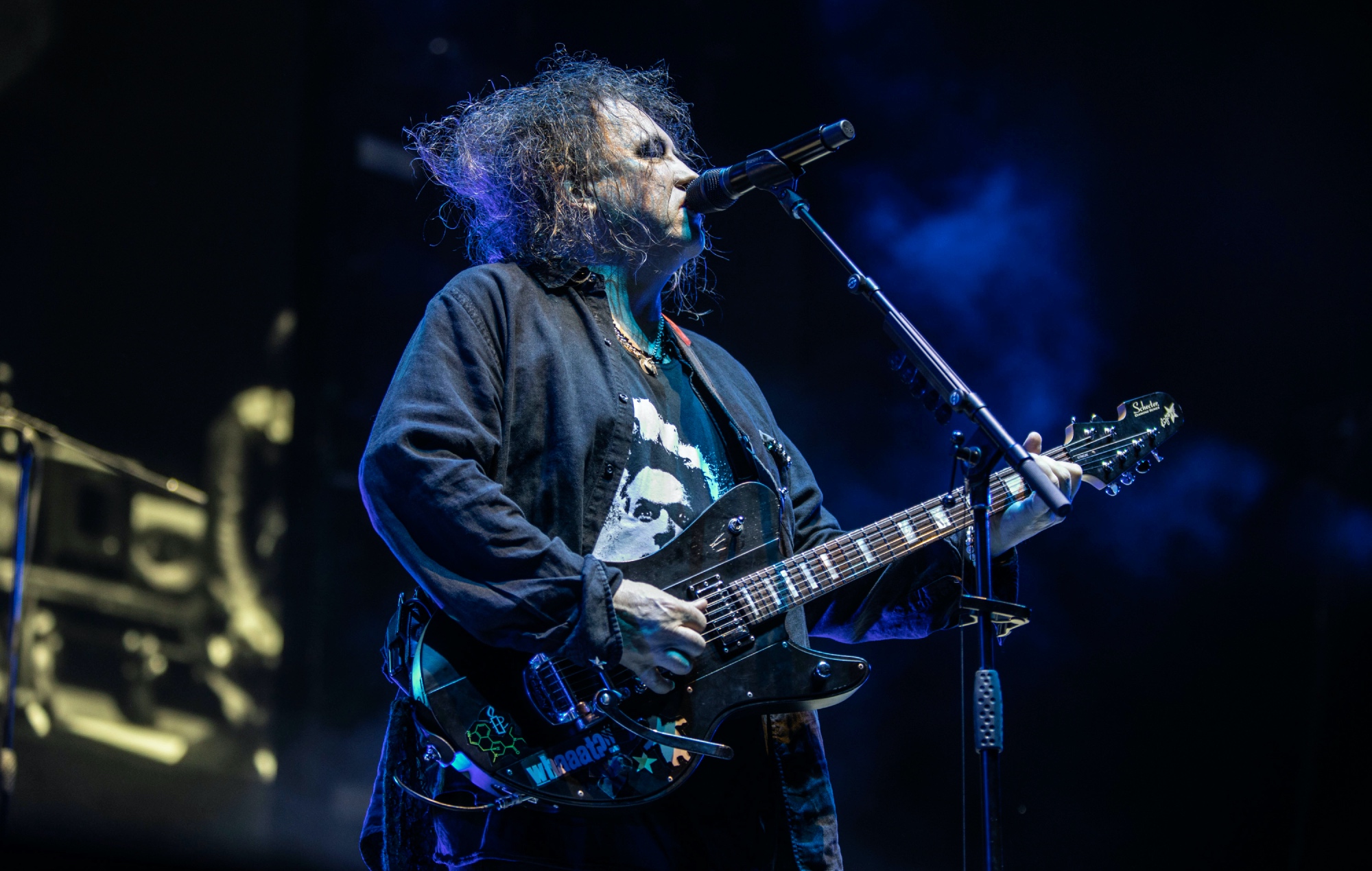 Robert Smith performing live on stage with The Cure